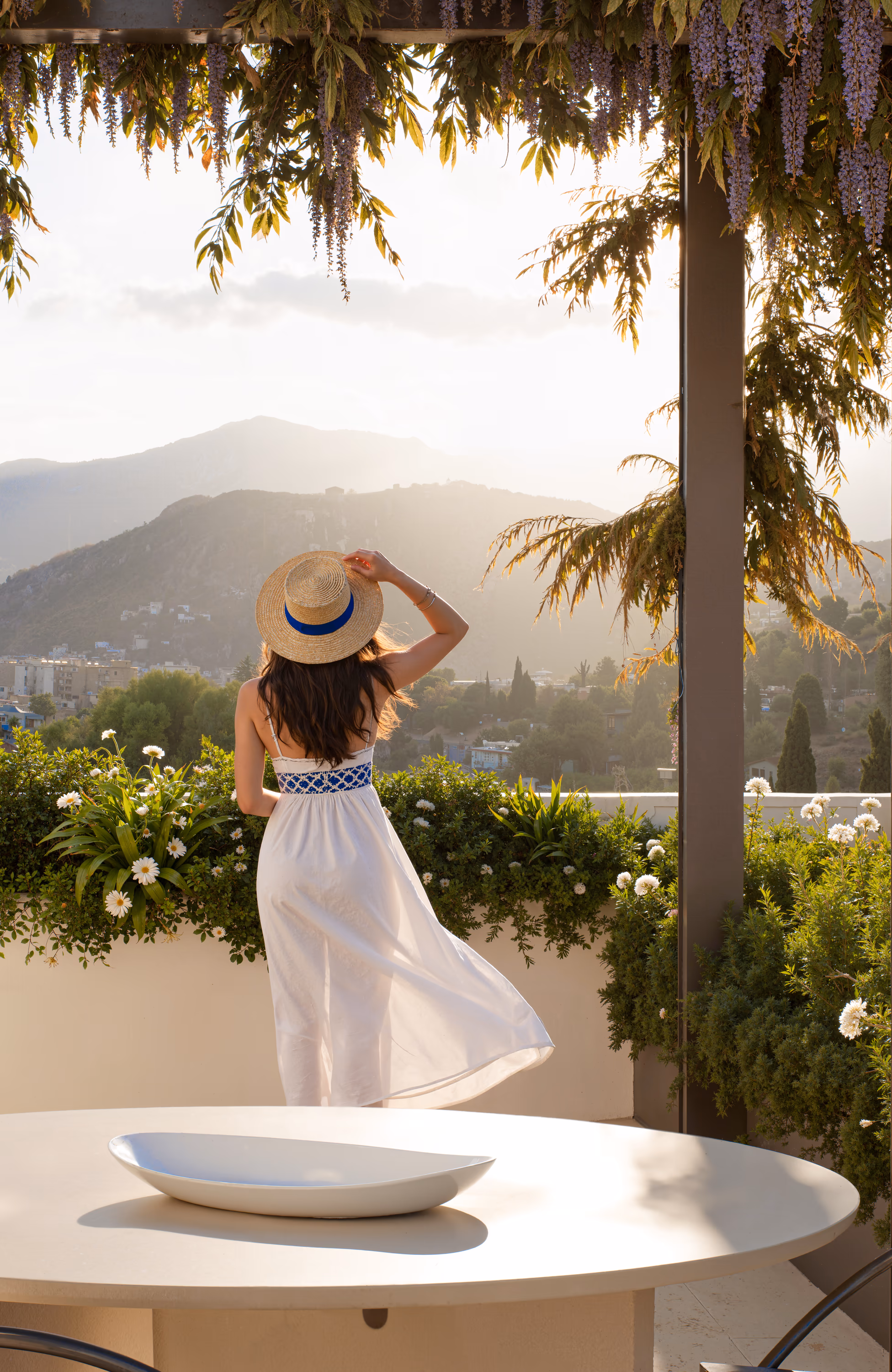 Woman standing on a terrace at sunset